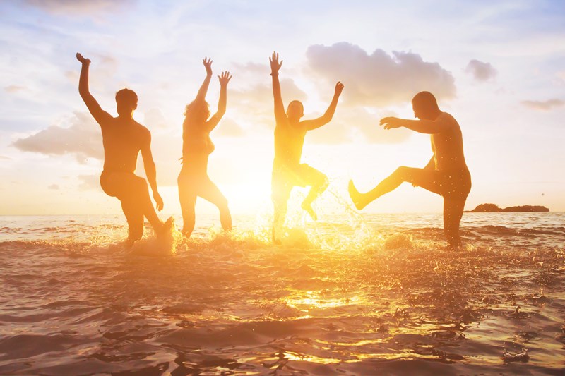 team building on the beach in the summer at sunset